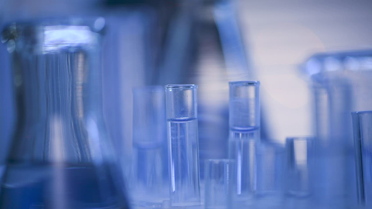 Glass laboratory test tubes and beakers in blue light